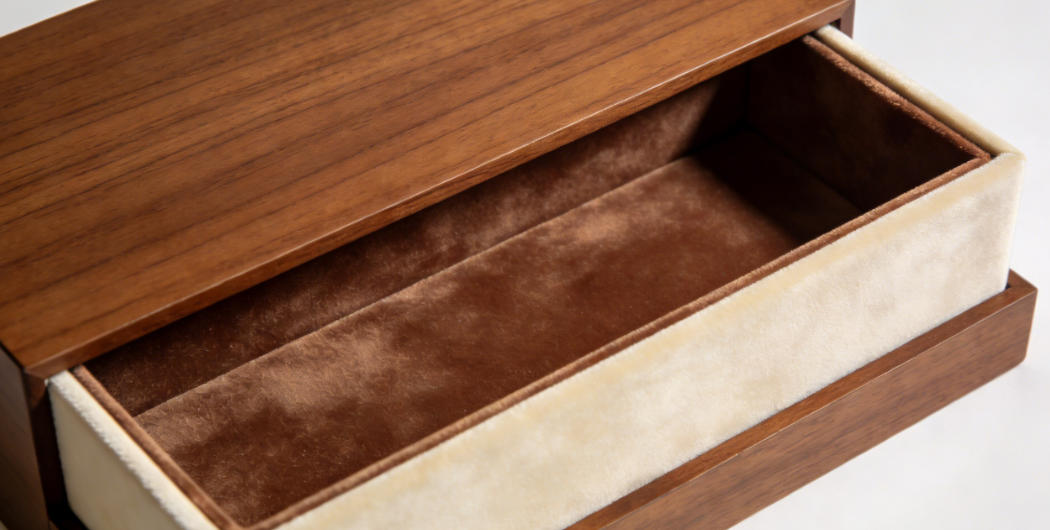 A close-up of the velvet lining inside a wooden jewelry box
